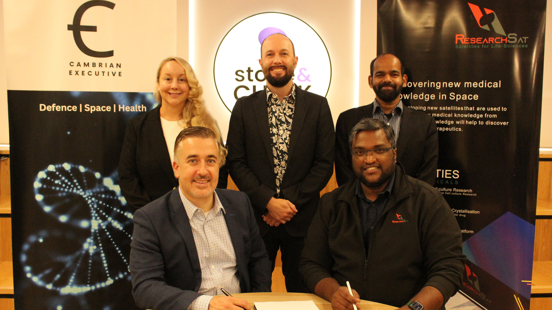 Cambrian Executive Cofounder & Director Research & Development Tiffany Sharp (Left back row) Stone & Chalk General Manager Dr Tim Mahlberg Sie (centre back row) ResearchSat Chief Technology Officer Jibin Jeffrey (Right back row) Cambrian Executive Cofounder & Managing Direct John Godwin (Left seated) ResearchSat Founder & CEO Ravi Duggineni (Right seated)